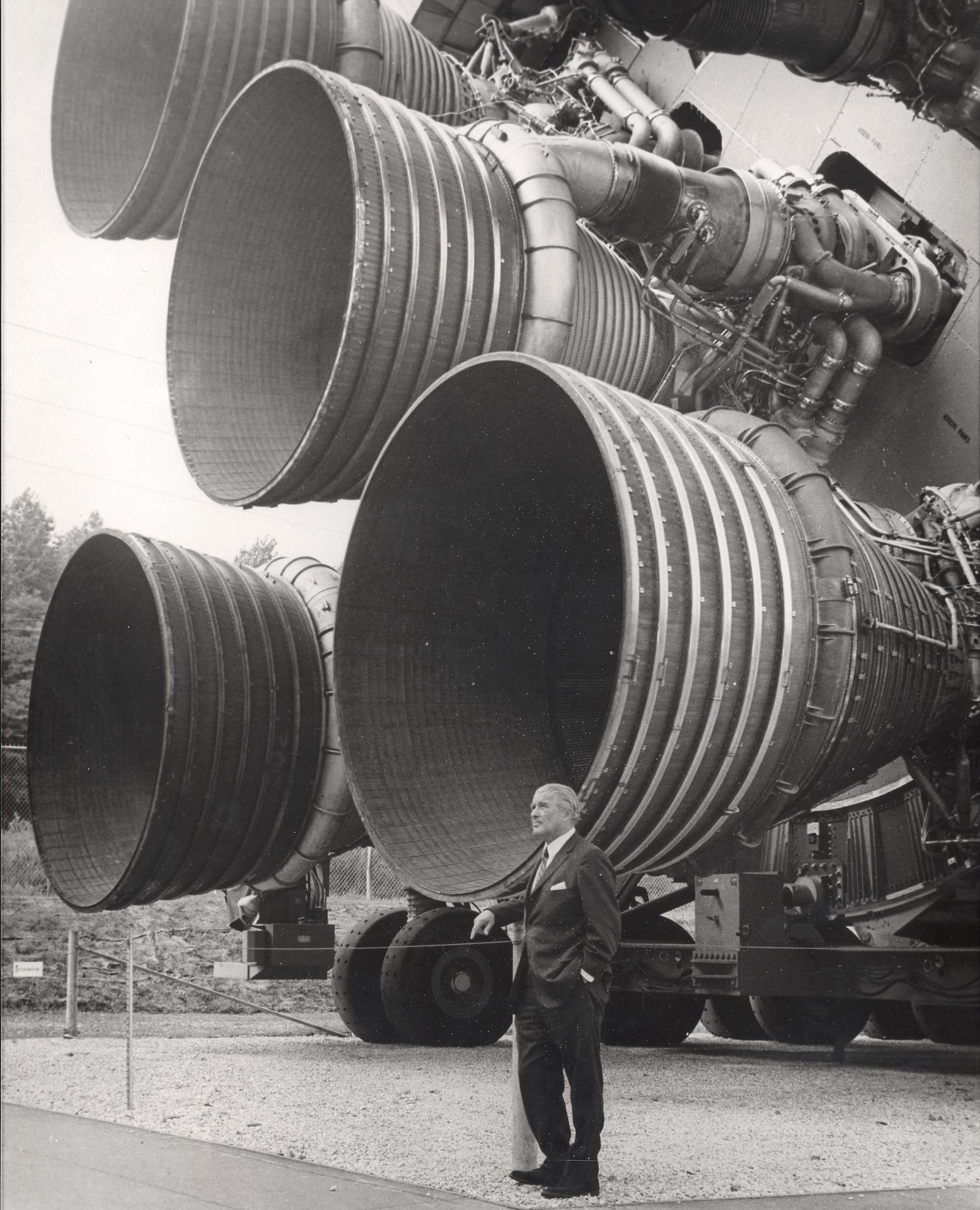 Wernher von Braun standing by the five F-1 engines at the base of a Saturn V first stage (NASA)