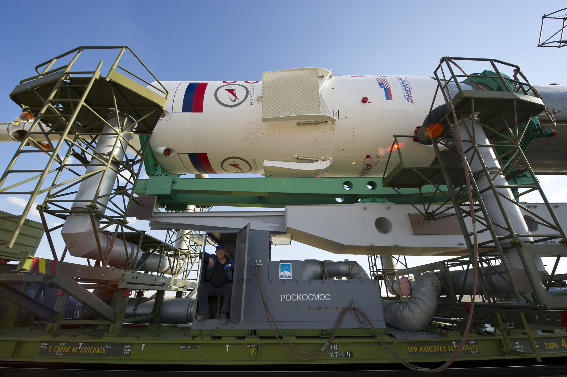 A Soyuz rocket rolls out to the launch pad — five engines, twenty main chambers, the shape the R-7 made famous (NASA)