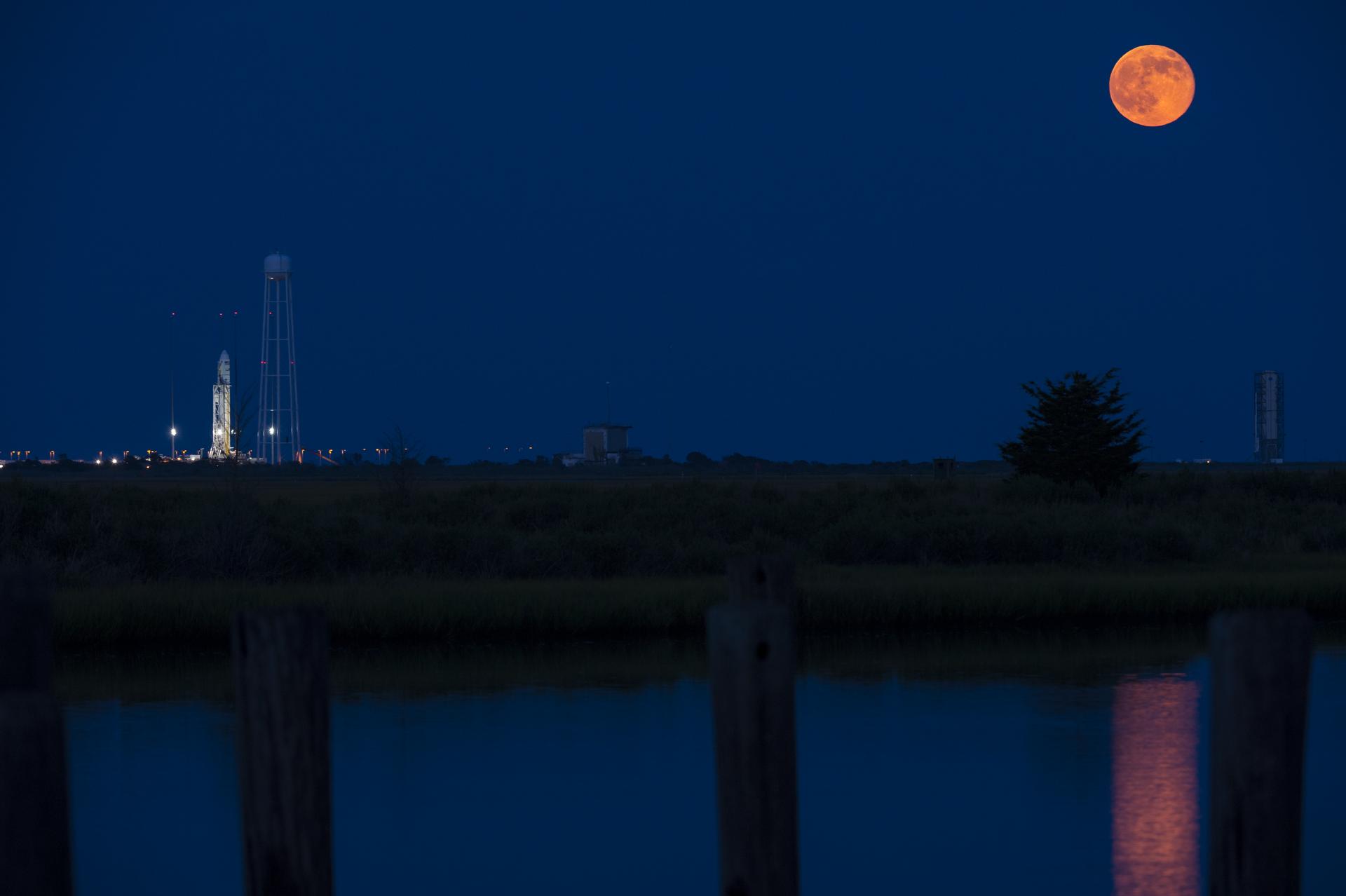 An Antares rocket stands at Wallops Flight Facility beneath a full moon — its first stage powered by AJ-26 engines derived from the NK-33 (NASA)