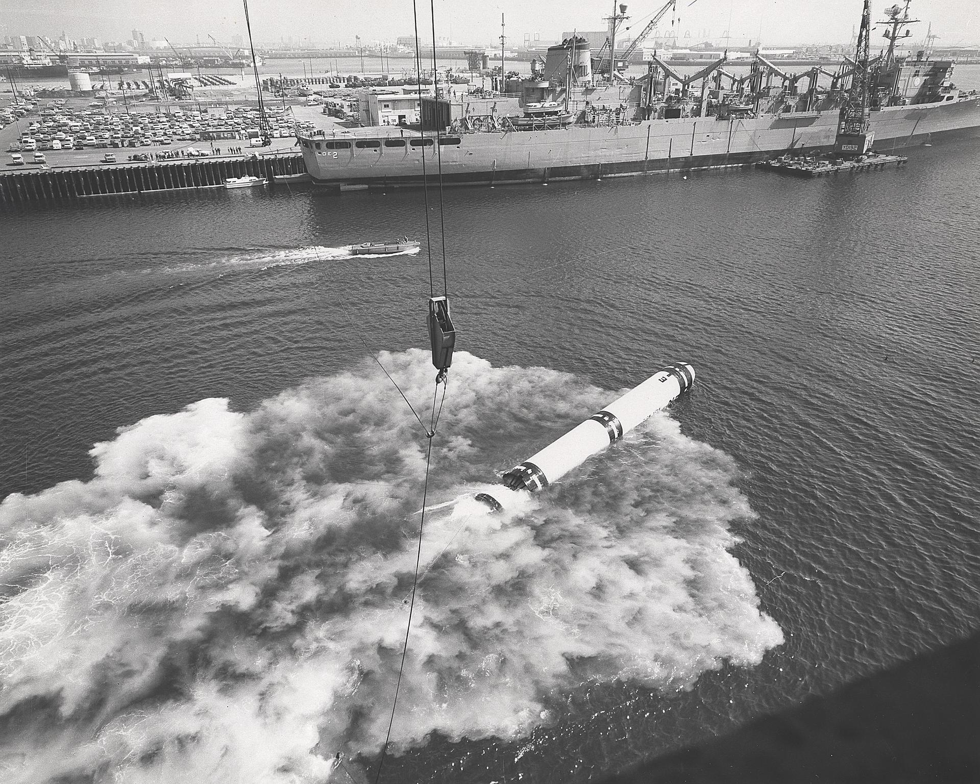 Water-entry recovery tests of a solid-fueled rocket booster casing at Marshall Space Flight Center — solid motors deliver simplicity and responsiveness at the cost of efficiency (NASA)
