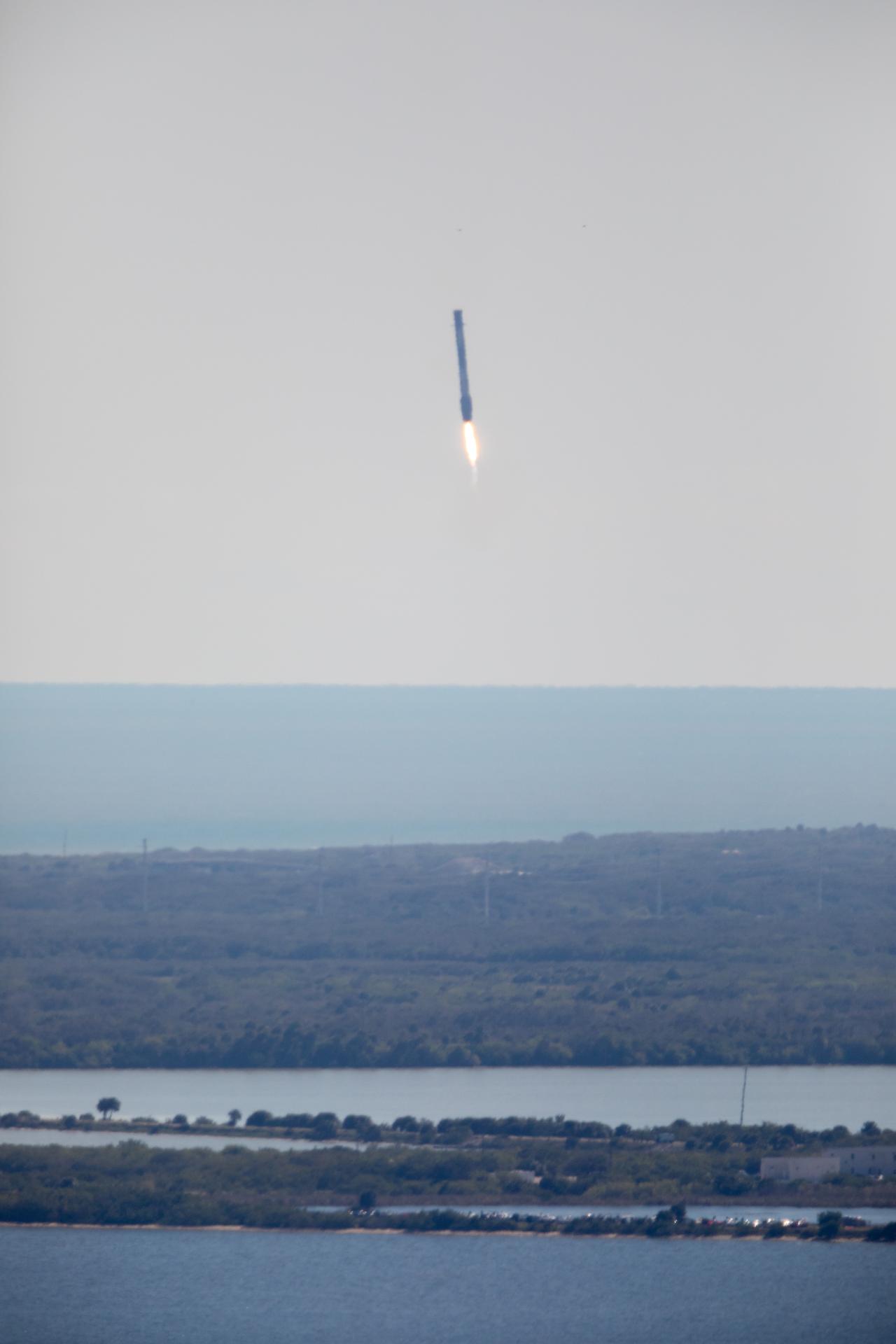 A Falcon 9 first stage returns for a land-based landing after the NG-20 cargo launch (NASA)