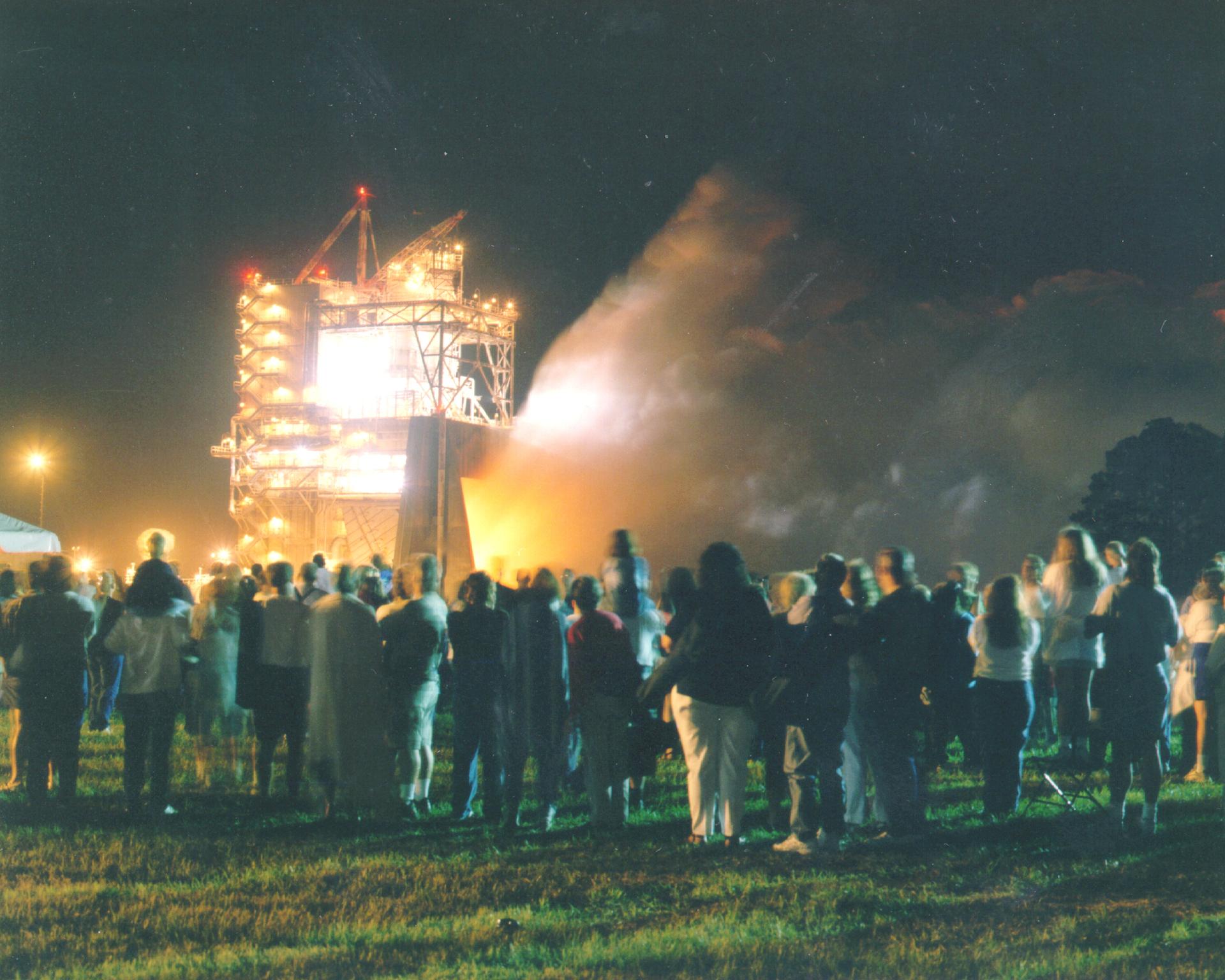 A Space Shuttle Main Engine test firing at Stennis draws an evening crowd (NASA)