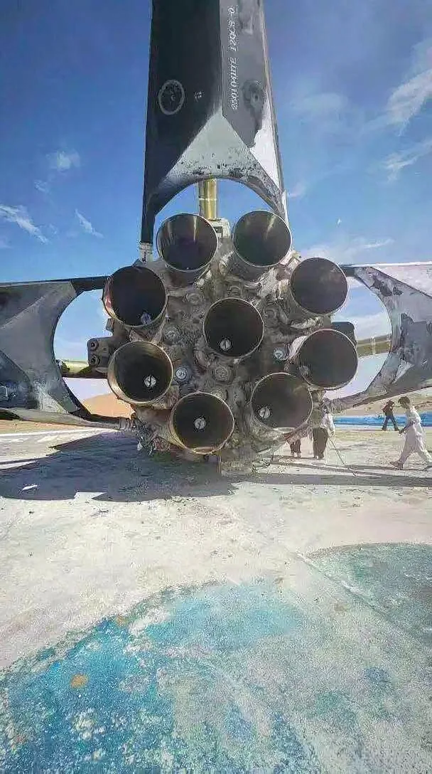 Close-up of the sooty engine section of the recovered Zhuque-3 first stage — the nine Tianque-12B engine nozzles after landing