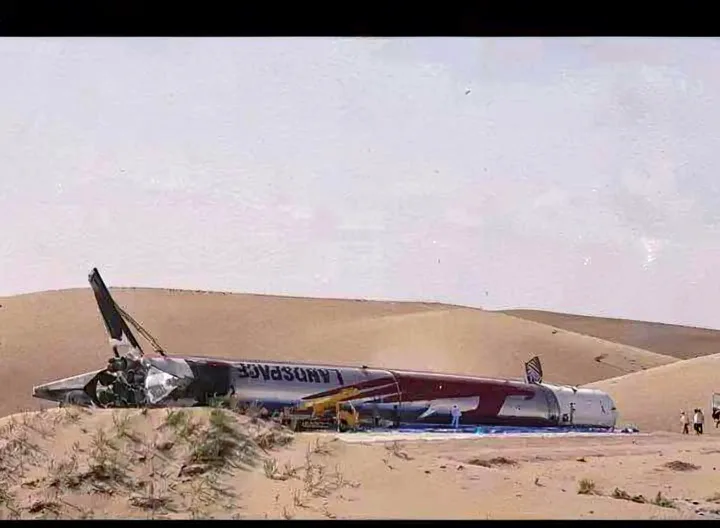 The Zhuque-3 first stage lying on its side in the desert after tipping over on the landing pad
